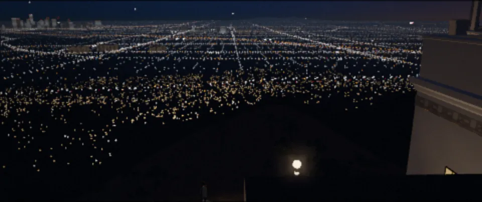 A grid of city lights seen from a hilltop terrace at dusk.