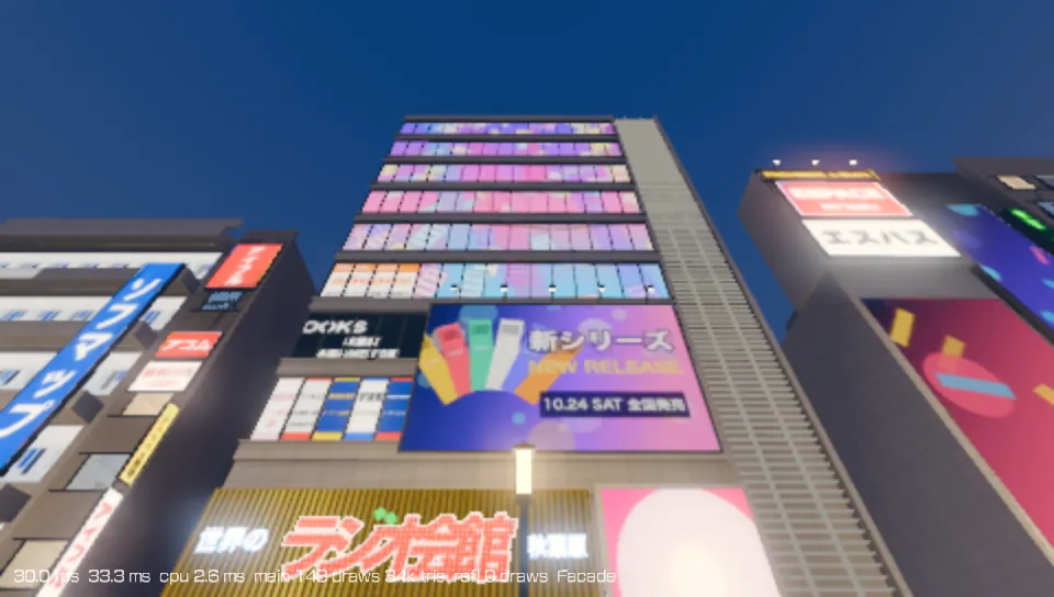 PS Vita capture: the Radio Kaikan building at dusk, its facade covered in lit signs.